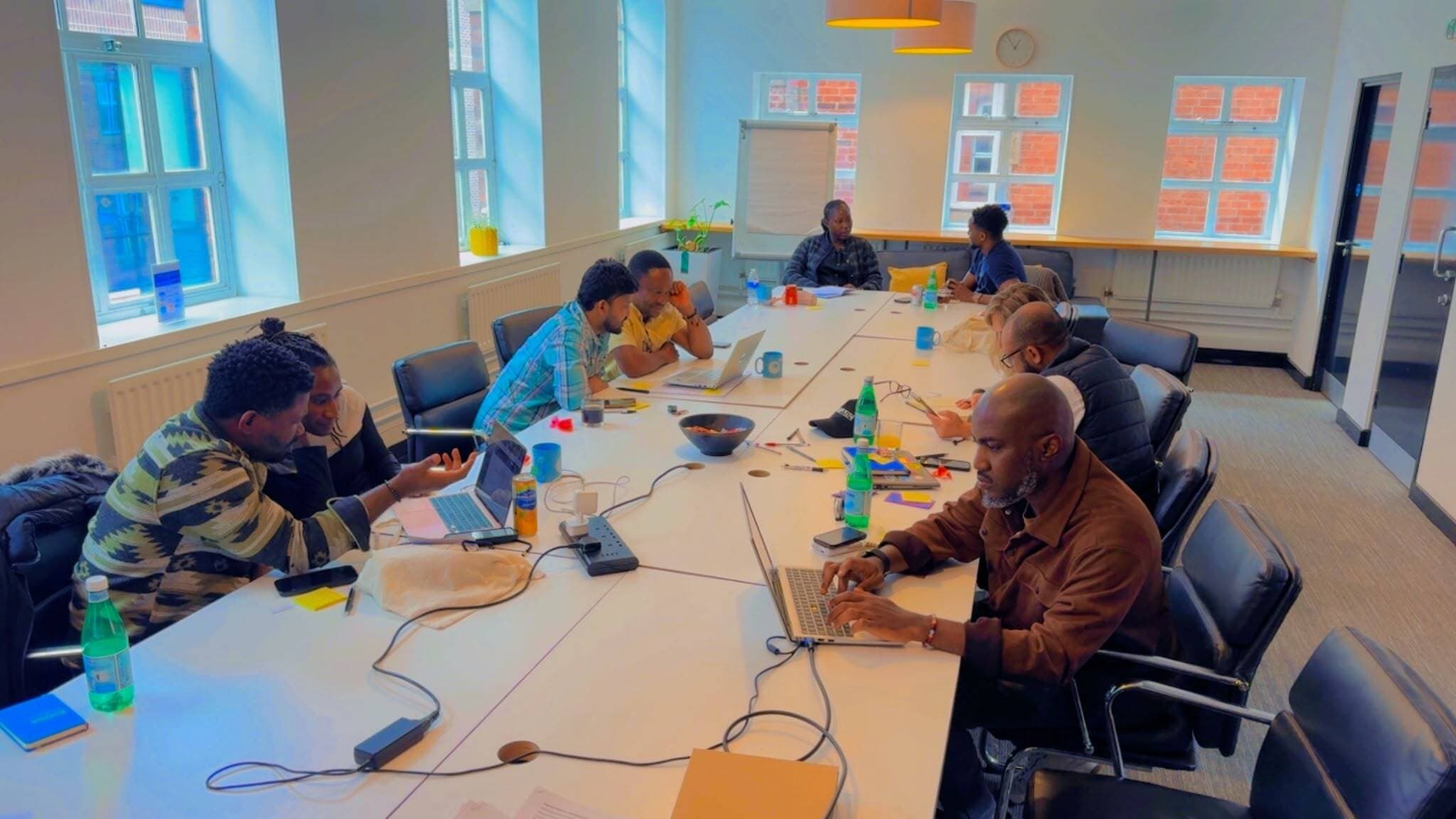 SYBTE team members working together around a table